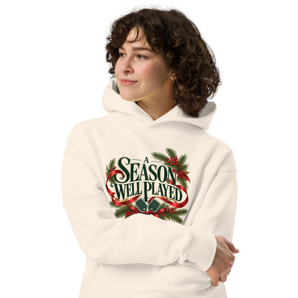 Burgundy ribbon, evergreen branches and pickleball paddles on Bone hoodie